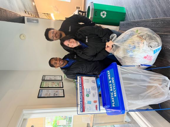 Ballinger Commons staff holding up their first full bag of plastic bags.